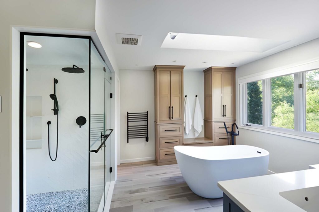 A contemporary modern bathroom design. featuring a freestanding bathtub and a glass shower stall