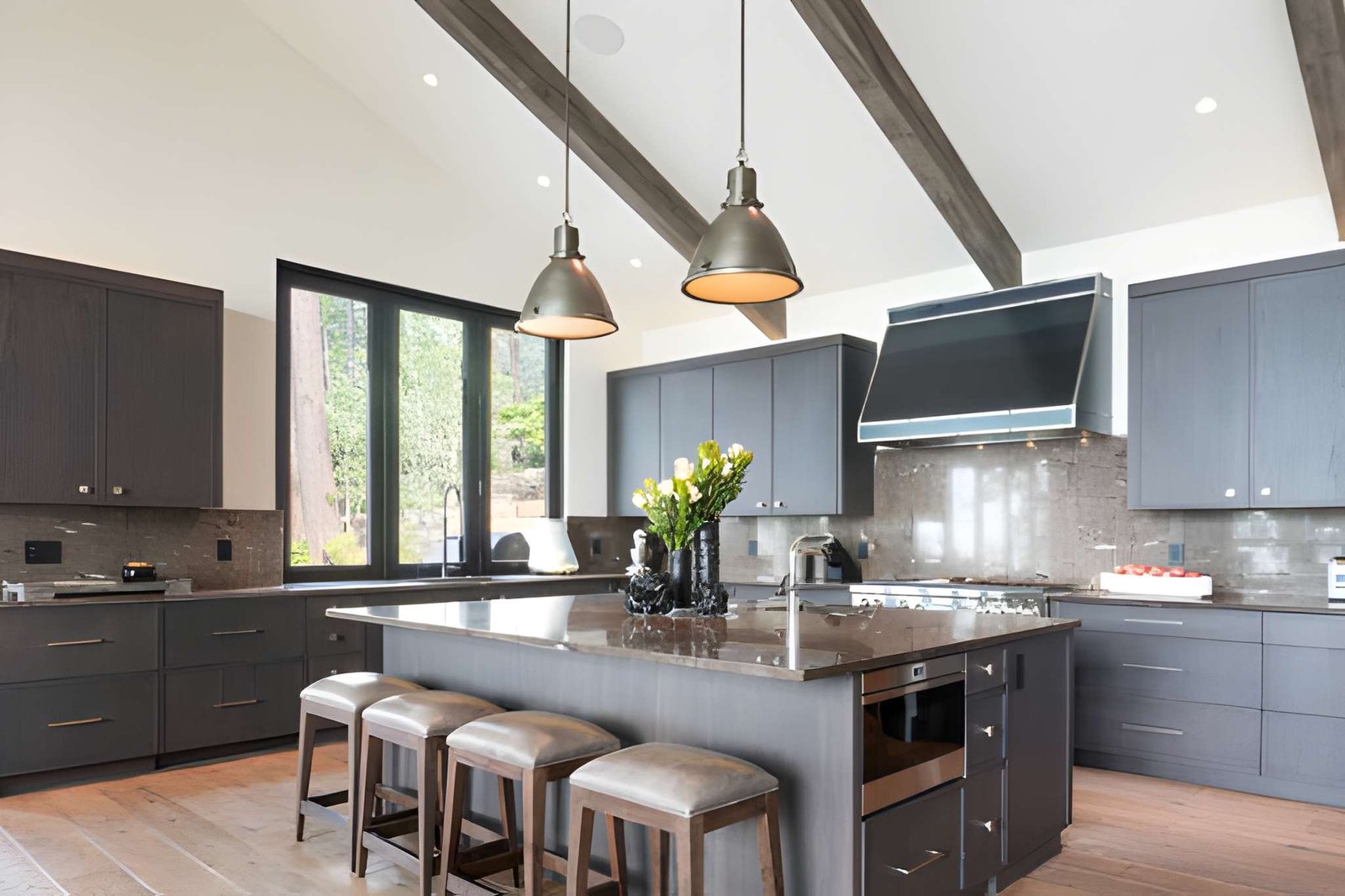 Kitchen island with four stools and two pendant lights above