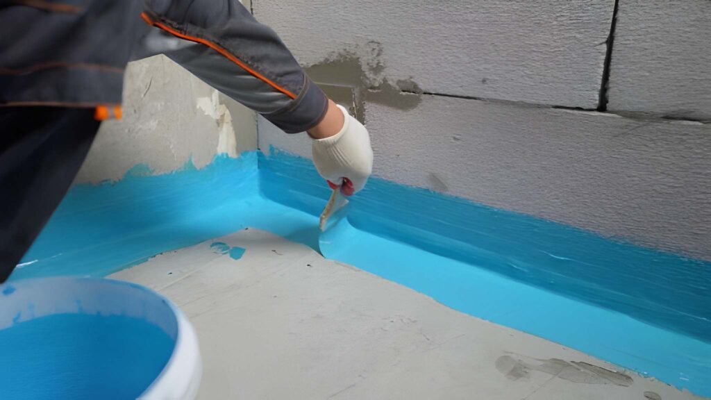 The waterproofing coating is blue. Cover the concrete wall with a cement-polymer waterproofing membrane. Waterproofing with a blue shade brush.