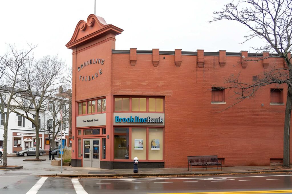 Modern brick campus building with angled red walls.