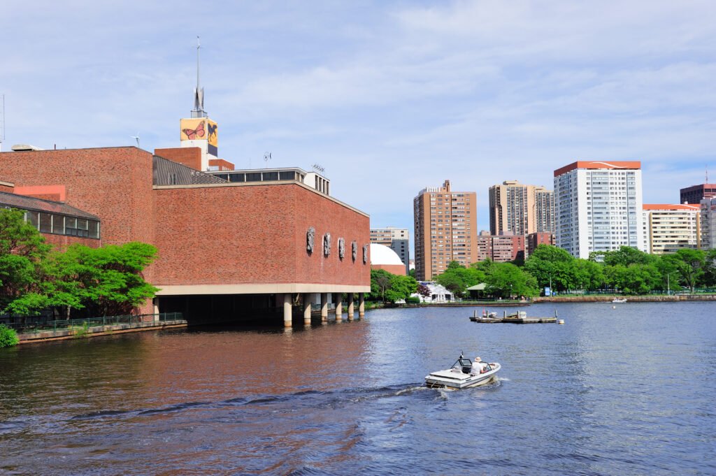 Boston skyline panorama over Charles River with boat and urban architecture.
