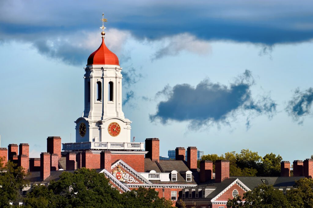 Red domed clock tower on brick building.
