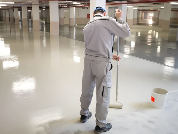 Manual worker putting non-slip layer on the floor