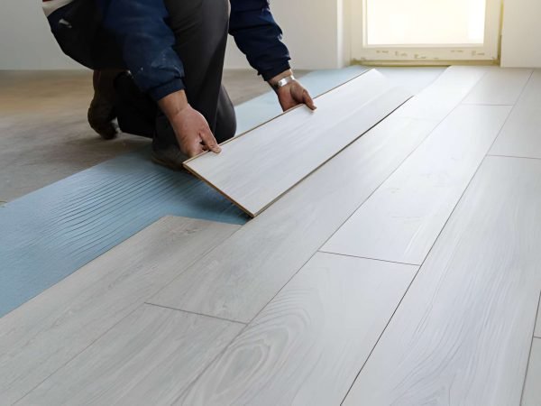 Worker carpenter doing laminate floor work